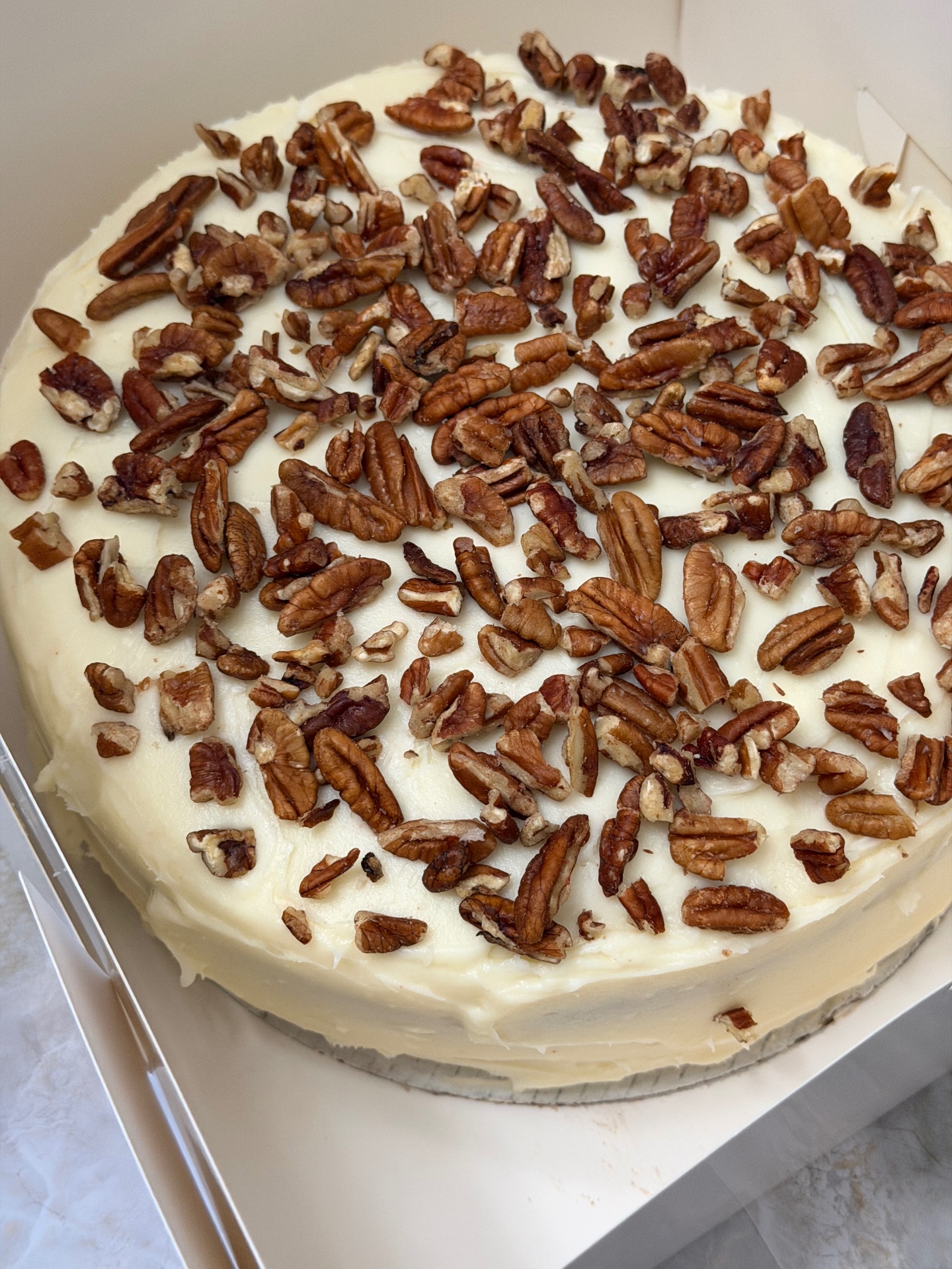 Red velvet cake topped with pecans